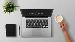 man using laptop on table against white background