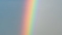 sky with rainbow over rippling blue ocean